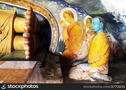 Monks seated near Buddha&rsquo;s feet