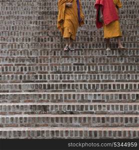 Monks walking down staircase, Luang Prabang, Laos