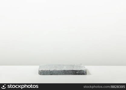 Monochrome gray template for mockup, banner. Flat granite pedestal on light gray background. Stone stand for natural design concept. Horizontal image, center composition, hard light, front view