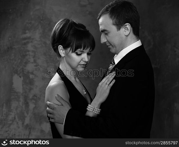 Monochrome picture of young man and woman in elegant evening dress