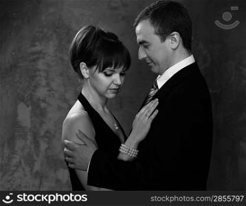 Monochrome picture of young man and woman in elegant evening dress