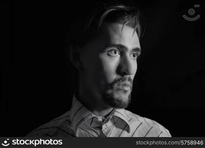 monochrome portrait of a young handsome man on black background