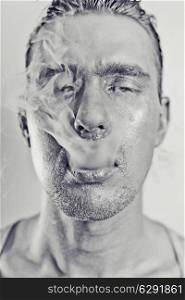 monochrome portrait of young attractive man with a silvery makeu in the smoke