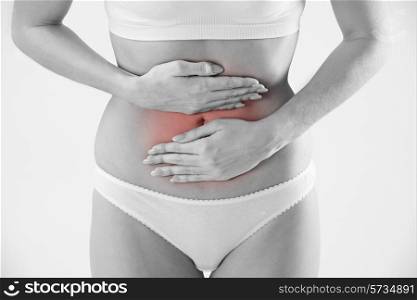 Monochrome Shot Of Woman In Underwear Holding Stomach In Pain