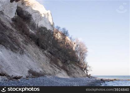 Mons Klint in Denmark. Mons Klint in Denmark in spring seen from the beach with blue water and sky