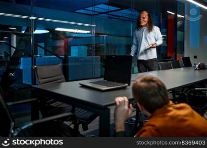 Monster corporate. Zombie boss entering night boardroom and scary man employee hiding under meeting table. Zombie boss entering night boardroom, scary man under table