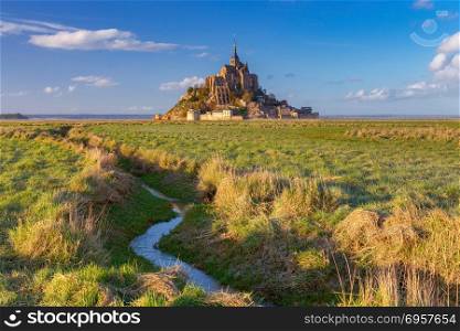 Mont Saint-Michel at sunset.. View of the Abbey Mont-Saint-Michel at sunset. France. Normandy.