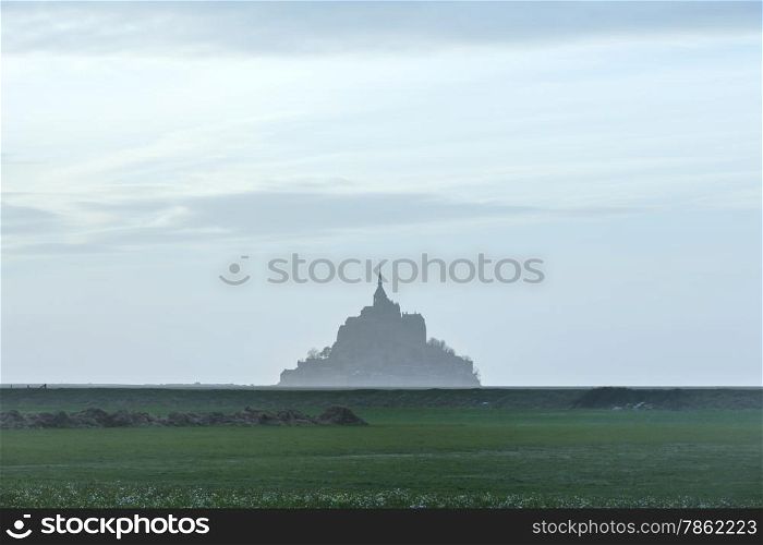 Mont Saint-Michel in March. Evening hazy view. France.