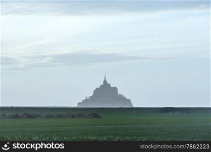 Mont Saint-Michel in March. Evening hazy view. France.