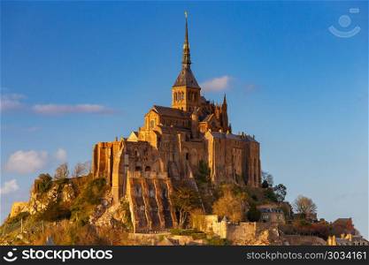 Mont Saint-Michel in the golden hour.. View of the Abbey Mont-Saint-Michel in the golden hour. France. Normandy.