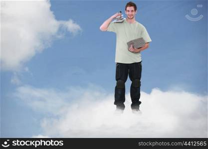 Montage of a smiling bricklayer standing on a cloud
