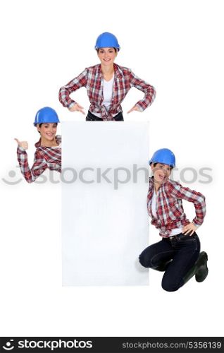 Montage of happy handywoman with white sign for message