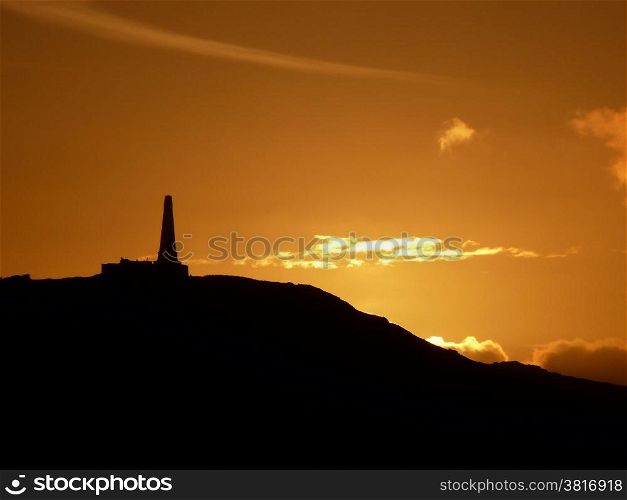 Monument at sunset. Old decaying hilltop monument in bright sunset