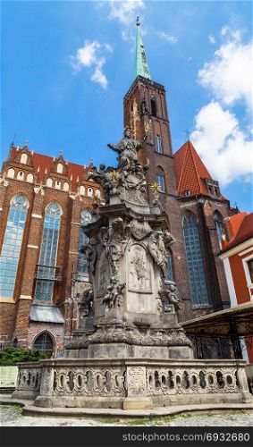Monument of St. John of Nepomuk and the Church of St. Bartholomew and the Holy Cross in Wroclaw. Poland