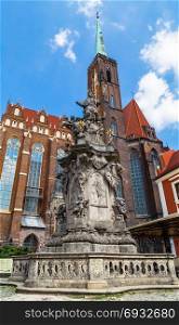 Monument of St. John of Nepomuk and the Church of St. Bartholomew and the Holy Cross in Wroclaw. Poland