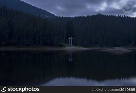 monument on the lake Synevir in Carpathian Mountains in Ukraine