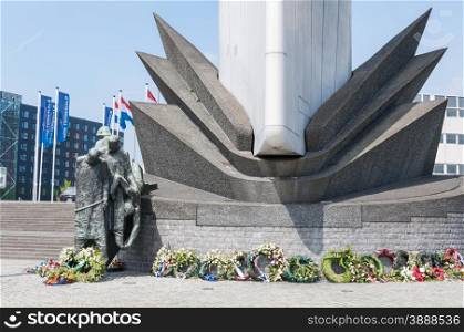 Monument on waterfront of Rotterdam with flowers in memorial of the World Wars. Netherlands