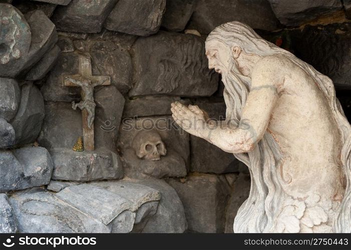 Monument praying elder in a cave. Lvov, Ukraine
