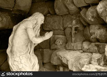 Monument praying elder in a cave. Lvov, Ukraine