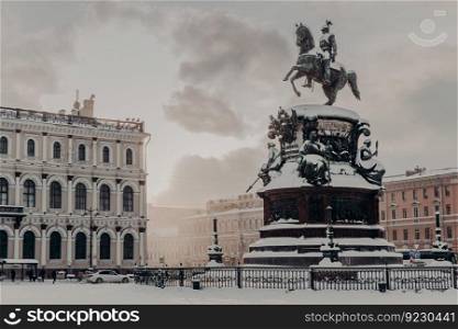 Monument to Nicholas I on Saint Isaac’s Square in Saint Petersburg at Russia. Historical monument during winter weather. Snowy view. City s landmarks.