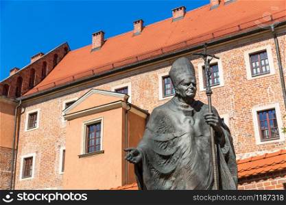 Monument to Pope John Paul II in Wawel cathedral castle, Krakow, Poland. European town with ancient architecture buildings, famous place for travel and tourism. Monument in Wawel cathedral castle, Krakow, Poland