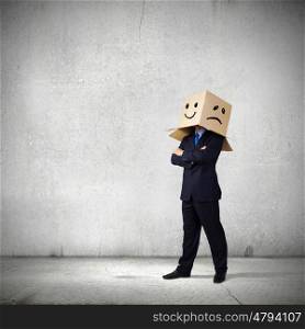Mood change. Businessman with box on head showing different emotions