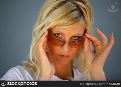 Moody blond woman wearing sunglasses