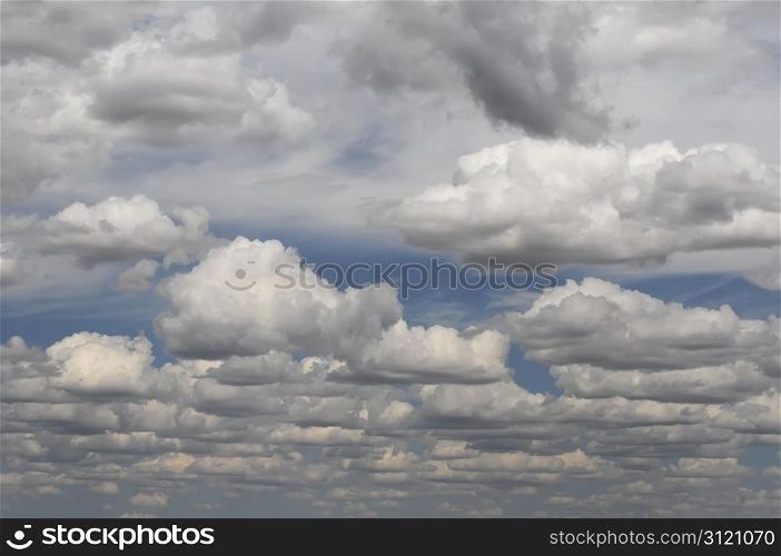 Moody dark clouds covering a peaceful blue sky