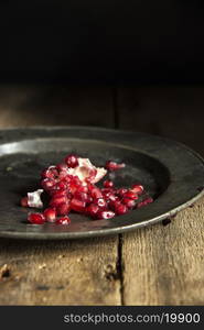 Moody natrual lighting images of fresh juicy pomegranate with vintage style