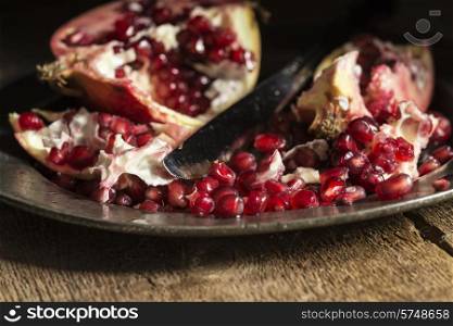 Moody natrual lighting images of fresh juicy pomegranate with vintage style