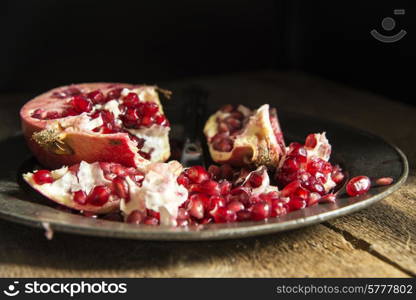 Moody natrual lighting images of fresh juicy pomegranate with vintage style