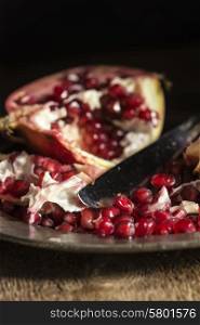 Moody natrual lighting images of fresh juicy pomegranate with vintage style
