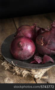 Moody natural light vintage style image of fresh red onions