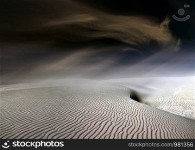 Moody sky. Moving sand dunes at Slowinski National Park near Leba, Pomeranian Voivodeship, Poland.