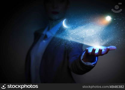 Moon and sun. Image of businessperson holding sun and moon o palm