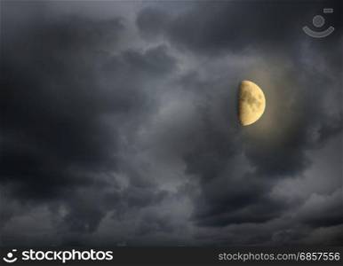 Moon in the night cloudy sky. Moon glowing in the dark night sky with stars. Cosmic landscape. Moon in starlit night