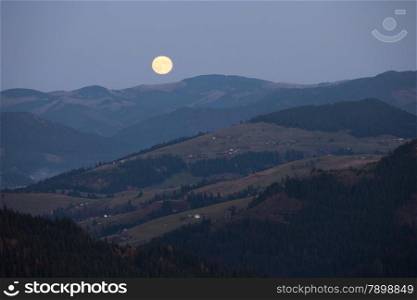 Moonrise over Carpathian mountains hills, Ukraine