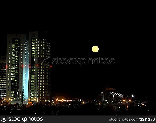 Moonrise over the distinctive West Bay district of Doha, Qatar, December 21, 2010.