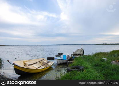 Moored rowing boats by the coast of Baltic Sea at the island Oland in Sweden.