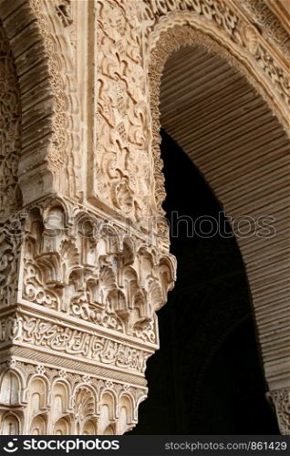 Moorish arch carved in stone on passage with ornament