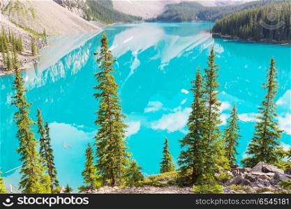 Moraine lake. Beautiful turquoise waters of the Moraine lake with snow-covered peaks above it in Banff National Park of Canada