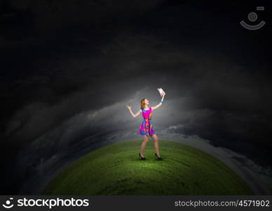 More colors. Young girl in multicolored bright dress and hat