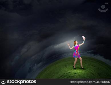 More colors. Young girl in multicolored bright dress and hat