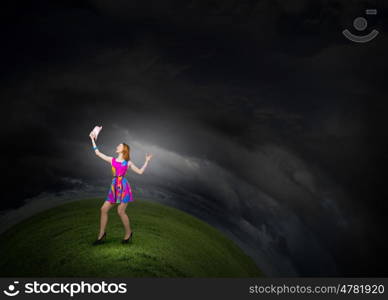 More colors. Young girl in multicolored bright dress and hat