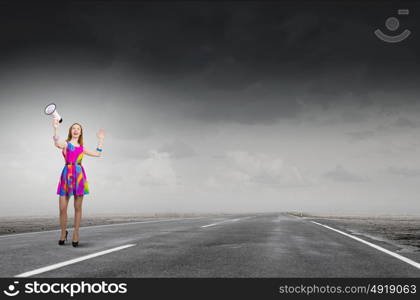 More colors. Young girl in multicolored bright dress screaming in megaphone