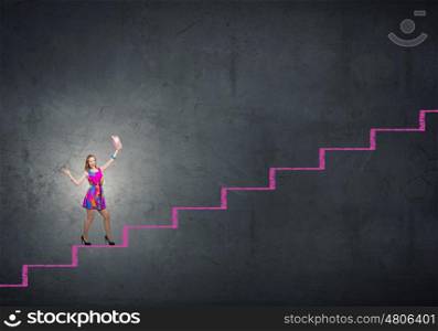More colors. Young girl in multicolored bright dress walking on staircase