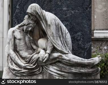 More than 100 years old statue. Cemetery located in North Italy.