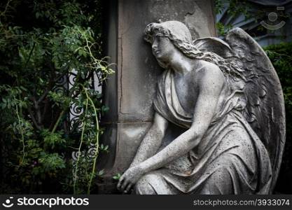 More than 100 years old statue. Cemetery located in North Italy.