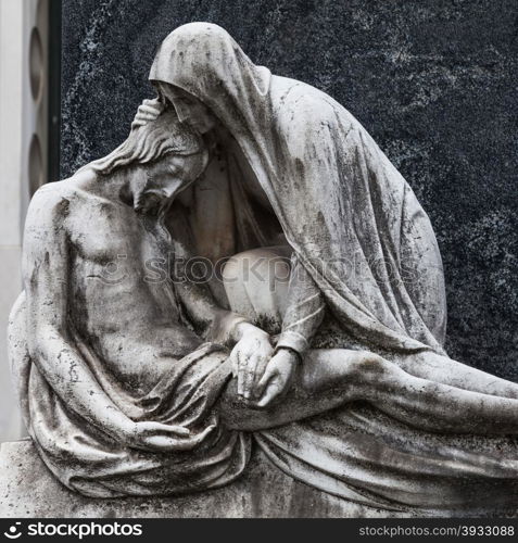 More than 100 years old statue. Cemetery located in North Italy.