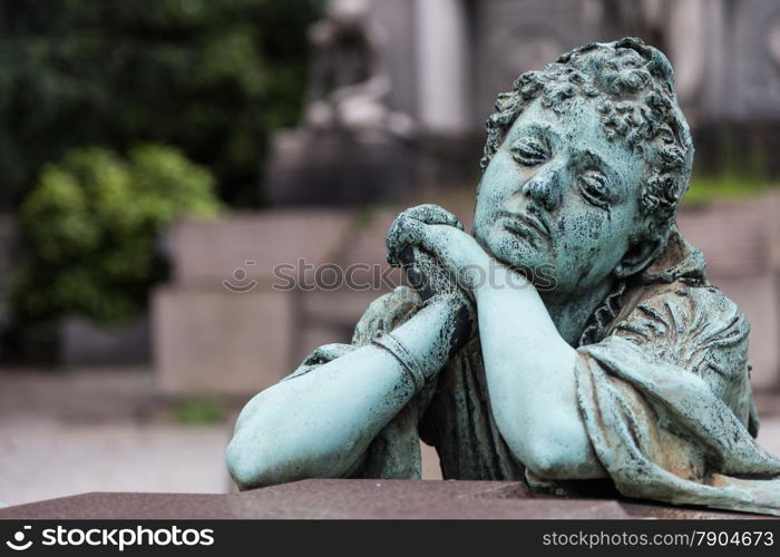 More than 100 years old statue. Cemetery located in North Italy.